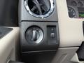 Close-up of the control panel in a 2008 Ford F-350 featuring the headlight adjustment dial and a switch for additional functions