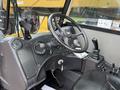 Interior view of a 2014 Caterpillar TL1055C forklift showing the steering wheel dashboard and control levers