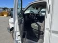 A 2013 Chevrolet Express van with an open door revealing the driver's seat and dashboard inside