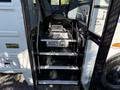 Interior steps of a 2013 International CE300 school bus with a warning sign to watch your step