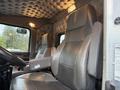 A high-back leather driver's seat inside a Kenworth T800 truck featuring armrests and a decorative tufted design on the ceiling