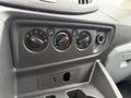 The dashboard controls of a 2017 Ford Transit T150 XLT featuring knobs for air circulation temperature and air conditioning along with a USB port and an auxiliary input slot