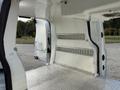 Interior view of a 2019 Ford Transit Connect showing a spacious cargo area with metal shelving and a textured floor