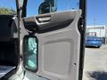 Interior door panel of a 2019 Peterbilt 337 featuring a handle and a small window