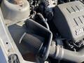 Close-up of a 2006 Pontiac G6 engine bay featuring an air intake system with a black filter and surrounding components