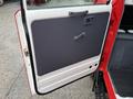 The image shows the open door of a 2001 Toyota Dyna with a white lower section and a grey upper panel featuring a handle and a small window control panel