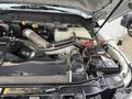 Close-up view of the engine compartment of a 2015 Ford F-450 featuring various components including hoses a radiator and a battery