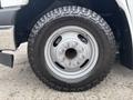 Close-up of a wheel with a Goodyear Wrangler tire on a 2020 Chevrolet Express showing the metal rim and tread details