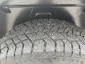Close-up of a rugged tire mounted on a 2016 RAM 1500 with a detailed tread pattern suitable for off-road traction
