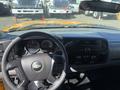 Interior view of a 2013 Chevrolet Silverado 1500 with a black steering wheel dashboard and control knobs visible