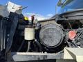 A 2014 International 7400 truck engine with various components including a black circular oil reservoir and attached hoses and gauges