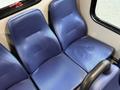 Interior seating of a Chevrolet Express with two blue upholstered seats designed for passengers