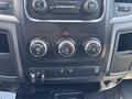 Dashboard controls of a 2013 RAM 2500 featuring knobs for air conditioning and ventilation settings along with a hazard light button