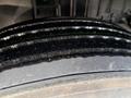 Close-up of the tire tread on a 2010 International 4300 showing multiple grooves and a textured surface