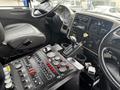 Interior view of a 2013 International DuraStar 4300 featuring a dashboard with various gauges switches and controls including a gear shift and steering wheel