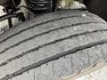 Close-up of a worn tire from a 2008 Ford F-550 showing significant tread wear and damage on the surface