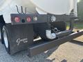 A 2008 Peterbilt 340 truck with a white tank body features rear lights and a black bumper with a pipe and gauges attached