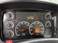 Dashboard of a 2005 Freightliner M2 106 showing various gauges including speedometer, tachometer, fuel and oil levels, and warning lights