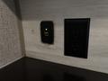 A power outlet with two sockets and a USB port is mounted on a wall with a light indicator that is green