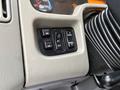 Control panel of a 2012 International 7400 featuring buttons for mirror adjustments light settings and panel controls