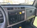 Interior dashboard of a 2015 Peterbilt 337 featuring gauges a stereo system control panel and various switches and knobs