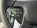 A close-up of the steering wheel control panel featuring buttons for cruise control labeled RES, CANCEL, OFF, ON, and SET