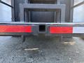 Close-up of the rear hitch area of a 2006 Freightliner M2 106 featuring a rectangular receiver and red reflective tape on both sides
