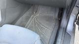 A 2018 Hyundai Sonata floor mat showing an intricate design with some dirt and debris visible on the surface