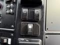 Dashboard controls of a 2010 Autocar Xpeditor featuring switches for power windows heated mirrors and additional controls