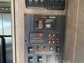 Control panel for a Cummins Onan generator in a 2021 Grand Design Recreational ST3478MBS with various buttons and indicators for starting and monitoring the generator