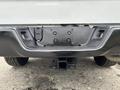 A 2013 RAM 1500 truck's rear bumper showing the tow hitch receiver with mounting points and plug-in access for towing equipment