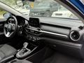 Interior view of a 2021 Kia Forte showcasing the dashboard with a touchscreen display and console featuring climate controls and a gear shifter
