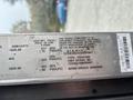 A 2012 Ford E-450 Super Duty vehicle identification label displaying specifications including tire pressure and vehicle compliance information
