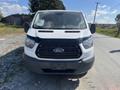 A 2017 Ford Transit van facing front with a white body and black grille featuring the Ford logo