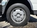 A close-up view of a silver wheel and tire from a 2015 Mitsubishi Fuso FE showcasing the tire tread and wheel design