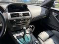 Interior of a 2004 BMW 6-Series showing the dashboard center console gear shifter and leather seats