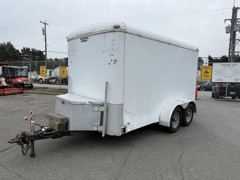 A white 2016 Continental cargo trailer with a square shape and a rear ramp door attached to a metal frame and dual axles