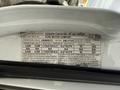 A 2002 Ford Econoline with a label showing vehicle specifications including weight limits tire sizes and recommended pressure