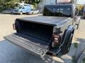 A 2021 Jeep Gladiator with the truck bed cover open revealing the cargo area