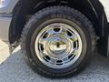 Close-up of a chrome wheel rim and tire on a 2019 Ford F-150 showcasing the detailed design and branding of the tire