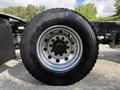 A close-up of a Goodyear Fuel Max tire mounted on a silver rim featuring multiple bolts and a black tread pattern