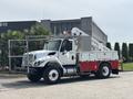 A 2012 International 7300 Workstar truck in white and red with a crane attachment and storage compartments on the side