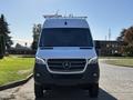 A 2024 Mercedes-Benz Sprinter 2500 viewed from the front featuring a sleek design with a prominent grille and the Mercedes logo on the hood