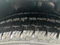 Close-up of the tread on a tire of a 2021 Mercedes-Benz Metris showcasing deep grooves and an even surface texture
