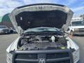 A 2012 RAM 2500 with its hood raised displaying the engine compartment and various components under the hood