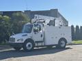 A 2005 Freightliner M2 106 truck with a white body and an elevated boom lift mounted on the back