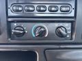 Control panel of a 2004 Ford F-750 featuring dials for temperature settings air conditioning and defrost functions