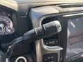 Close-up of a gear shift lever with a plus and minus button on a 2018 RAM 3500 dashboard
