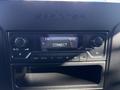 The dashboard display of a 2021 Mercedes-Benz Sprinter 2500 showing the audio control panel with various knobs and a screen indicating FM and the time 12:52