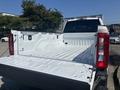A 2023 Ford F-350 SD pickup truck with an empty and clean truck bed visible in the foreground